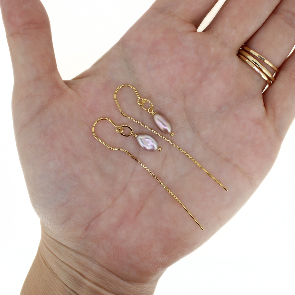 Brianne & Co. gold fill short threader earrings with light purple Edison keshi pearls on hand for size reference