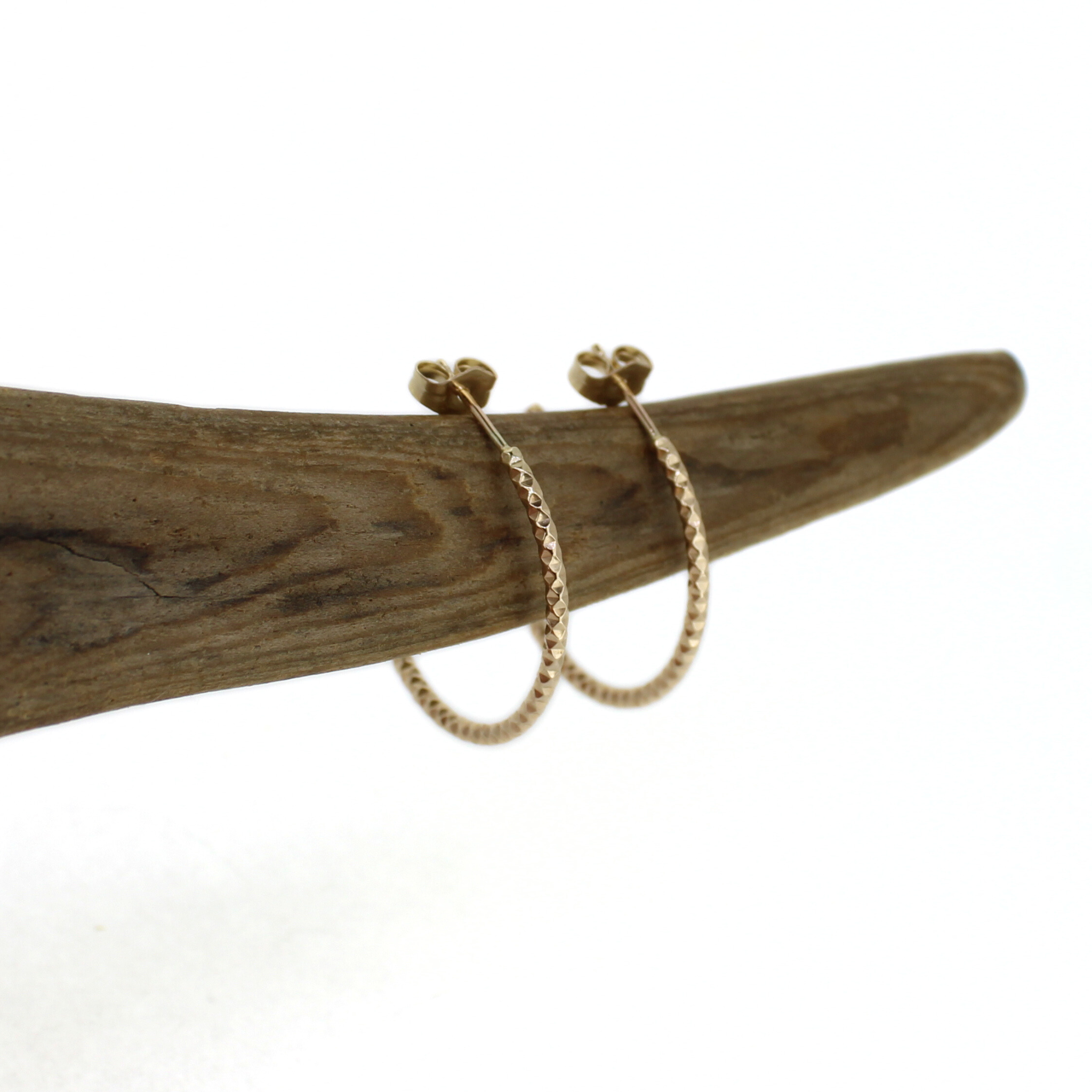 Brianne & Co. gold fill faceted hoop earrings close up view of texture