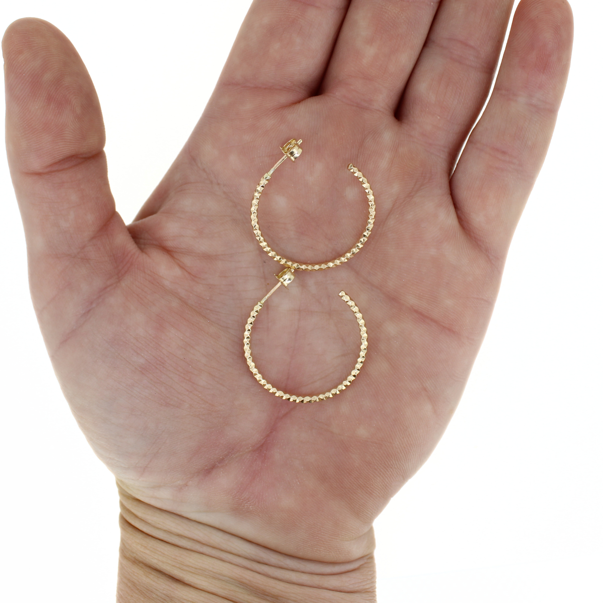 Brianne & Co. gold fill faceted hoop earrings on hand for size reference 