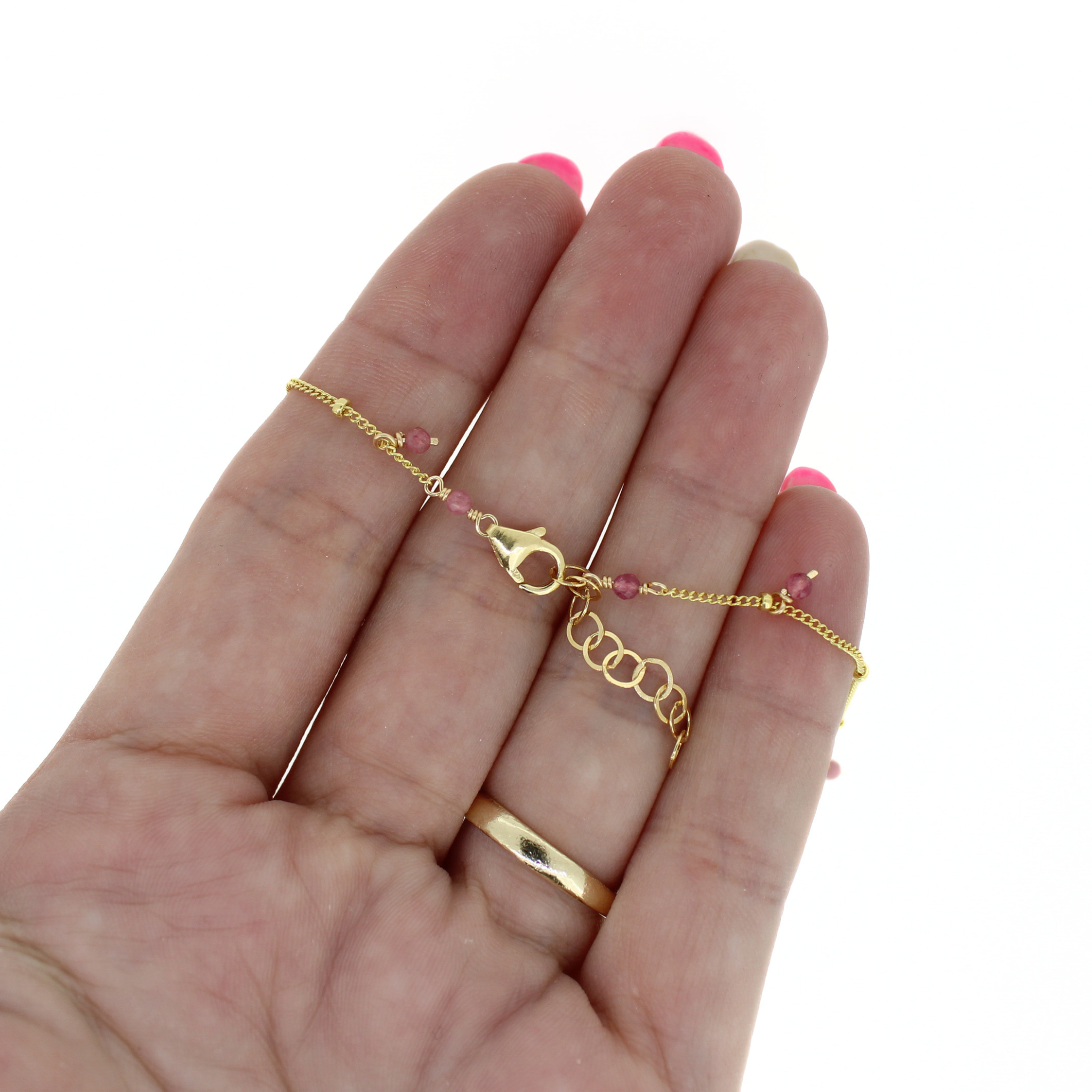 Gold fill anklet on hand, thin link chain with small pink gemstone beads and clasp