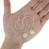 Brianne & Co. Gold Fill Puka Shell Tear Drop Hoop Earrings on hand for size reference