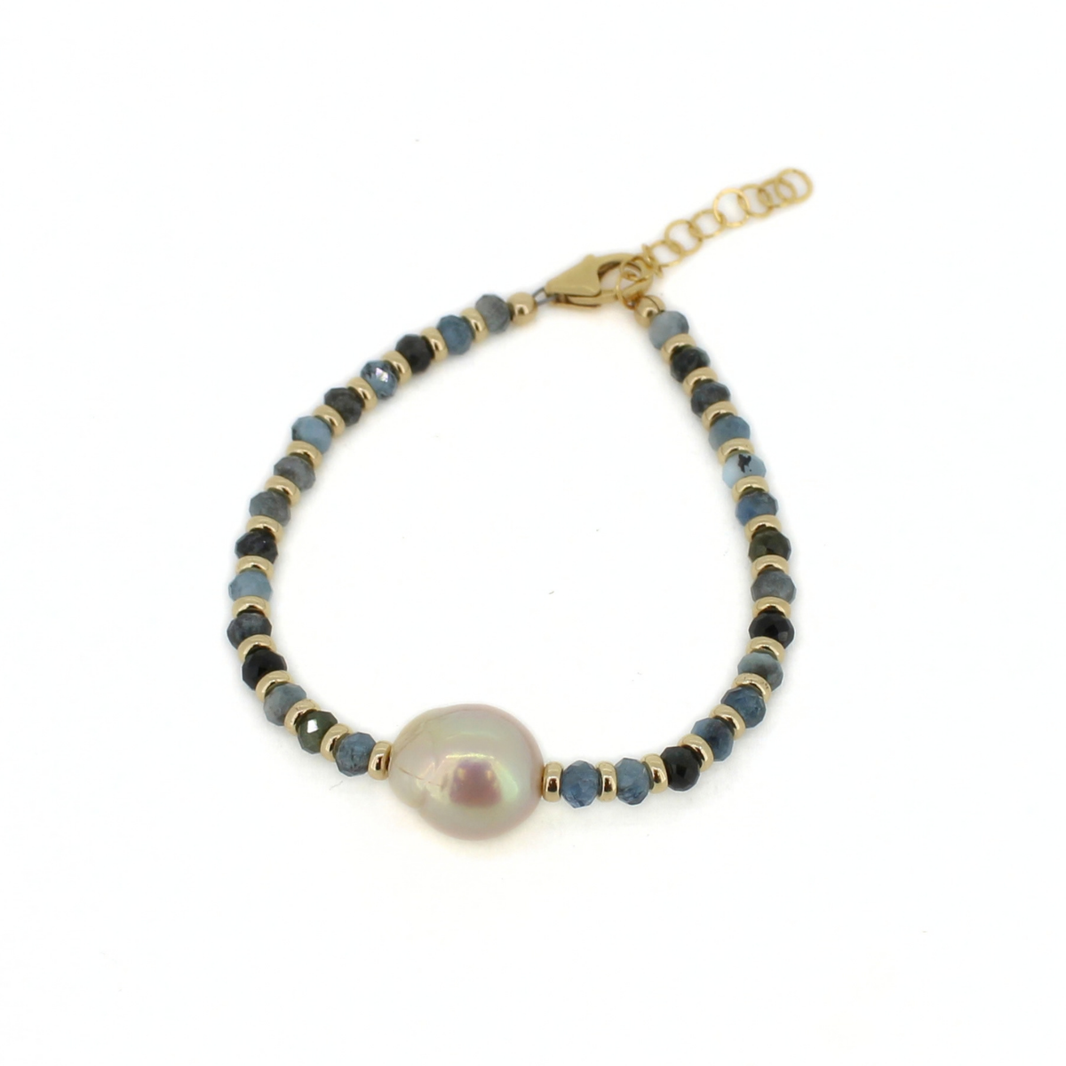 A delicate gold beaded bracelet featuring a large, lustrous baroque pearl at the center, accented with small round beads in shades of blue, black, and metallic gold, shown on a plain white background.