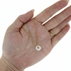 Brianne & Co. gold fill double chain white puka shell necklace on hand for size reference