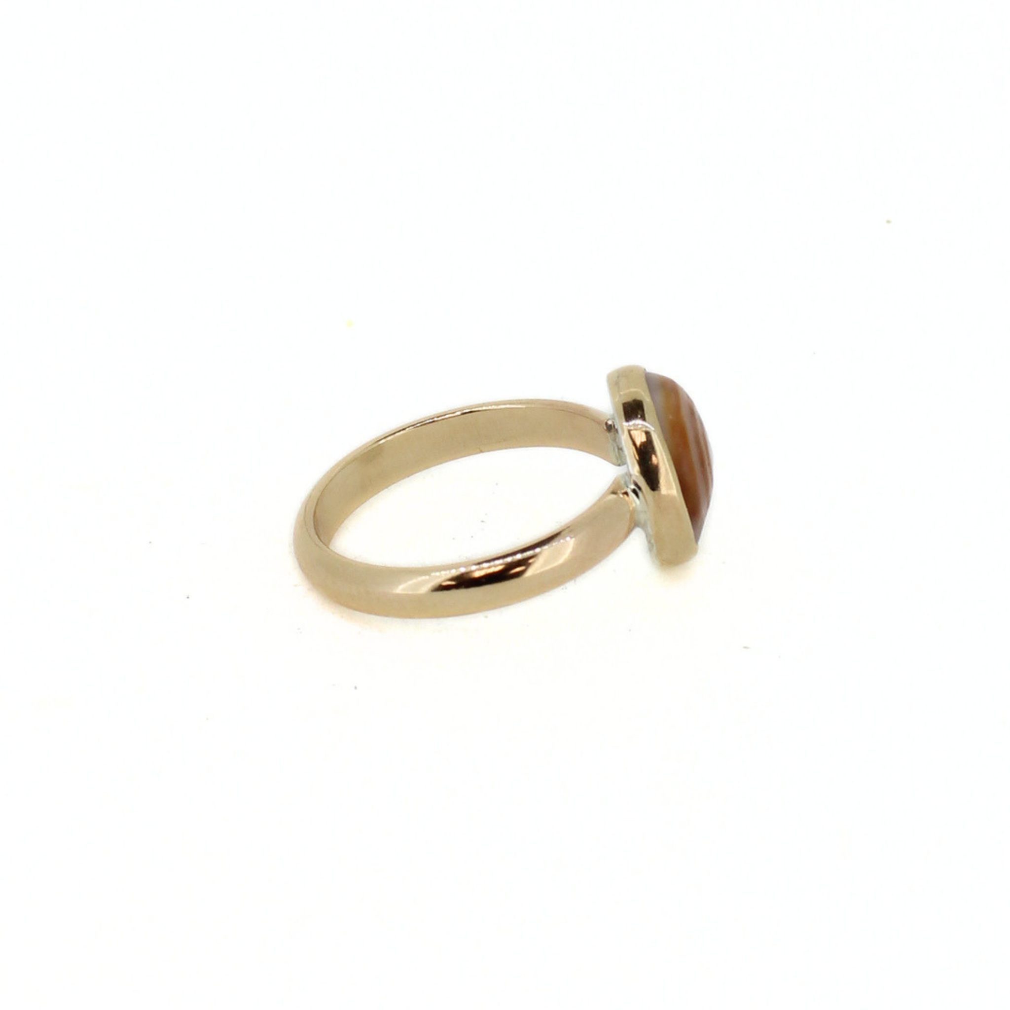 Gold-tone puka shell ring band with side view of oval shell setting