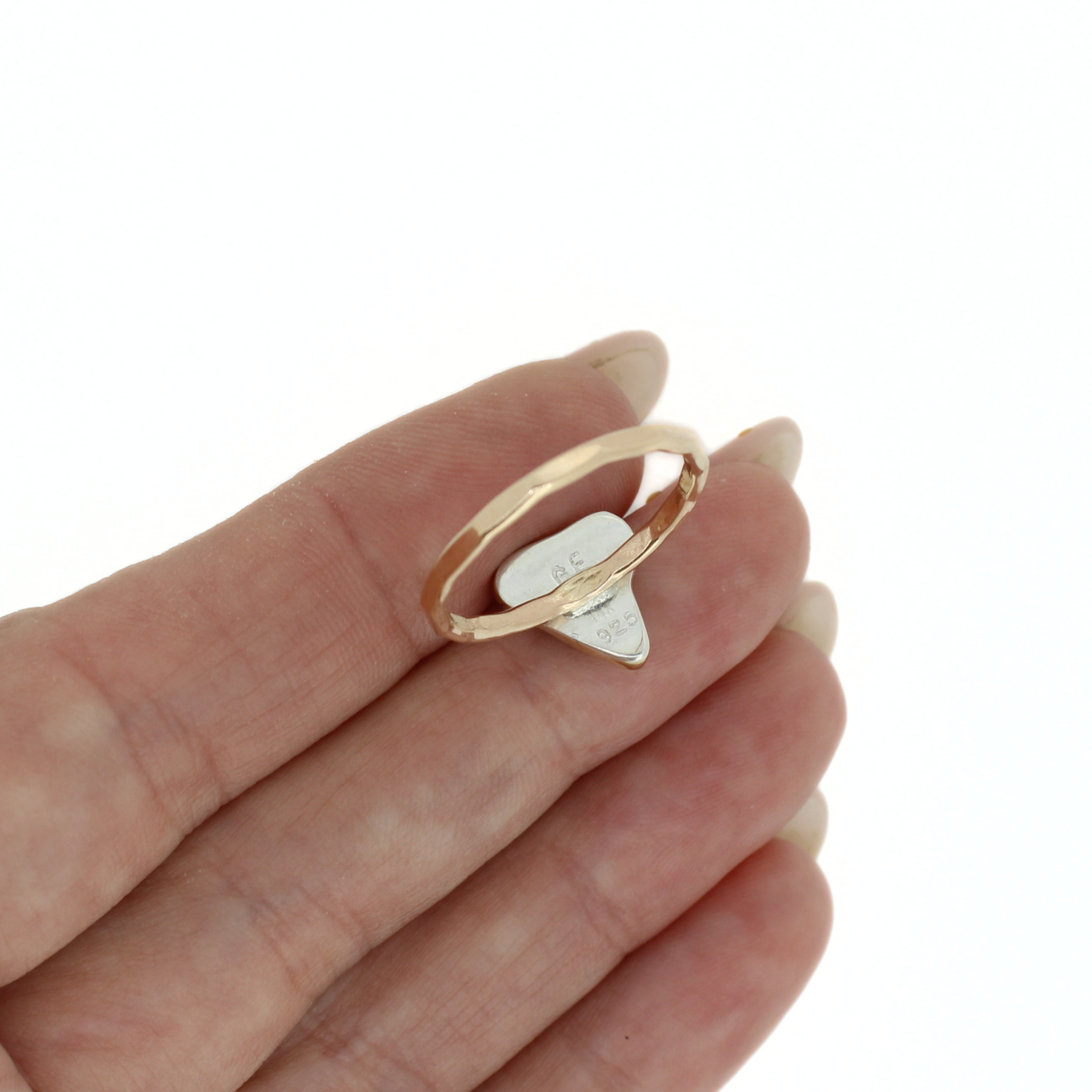 Gold shark tooth ring close-up in hand, band and tooth profile