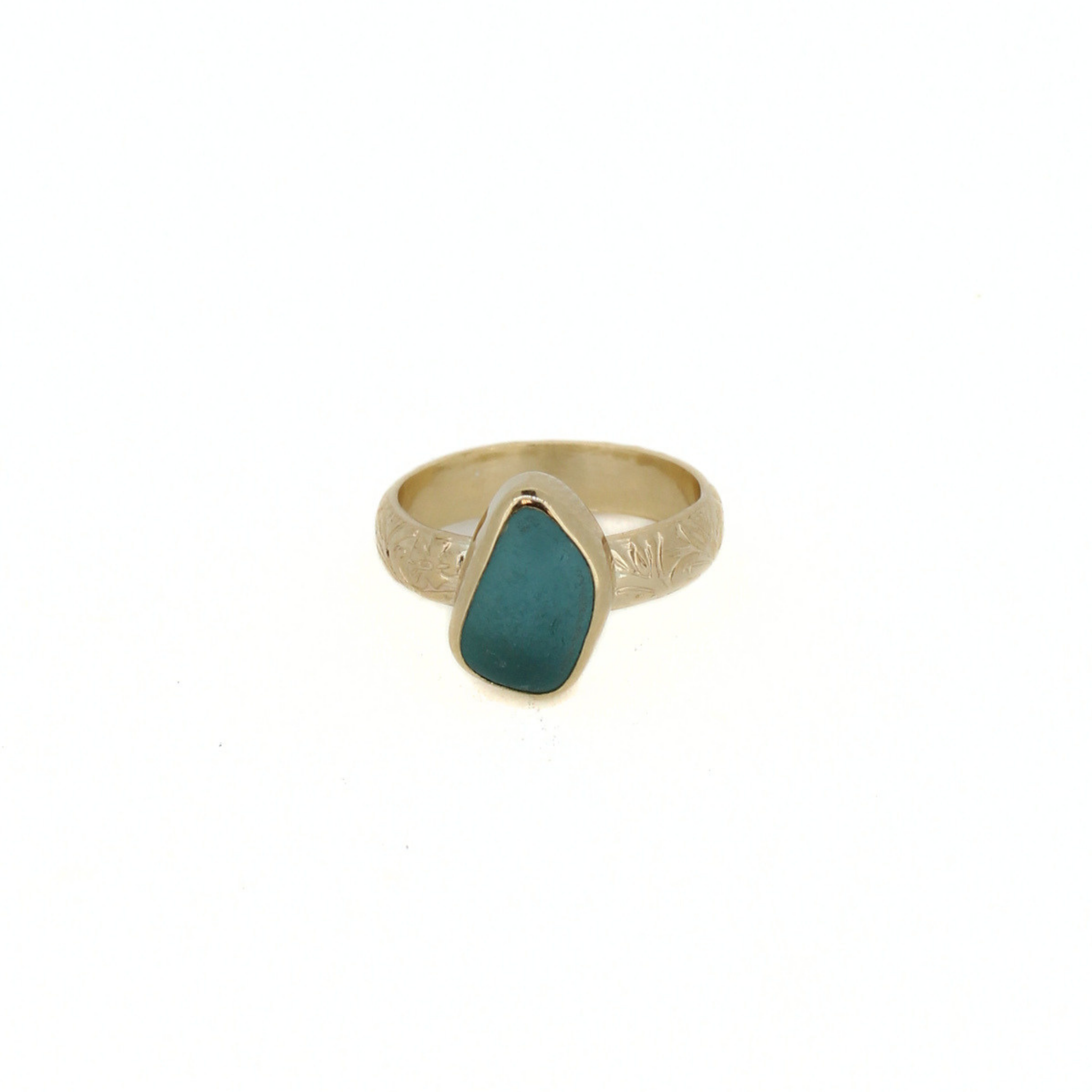 Gold-tone ring with teal sea-glass teardrop set in a silver-tone bezel.