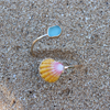 Brianne & Co. gold sunrise shell and sea glass bypass style cuff on the sand