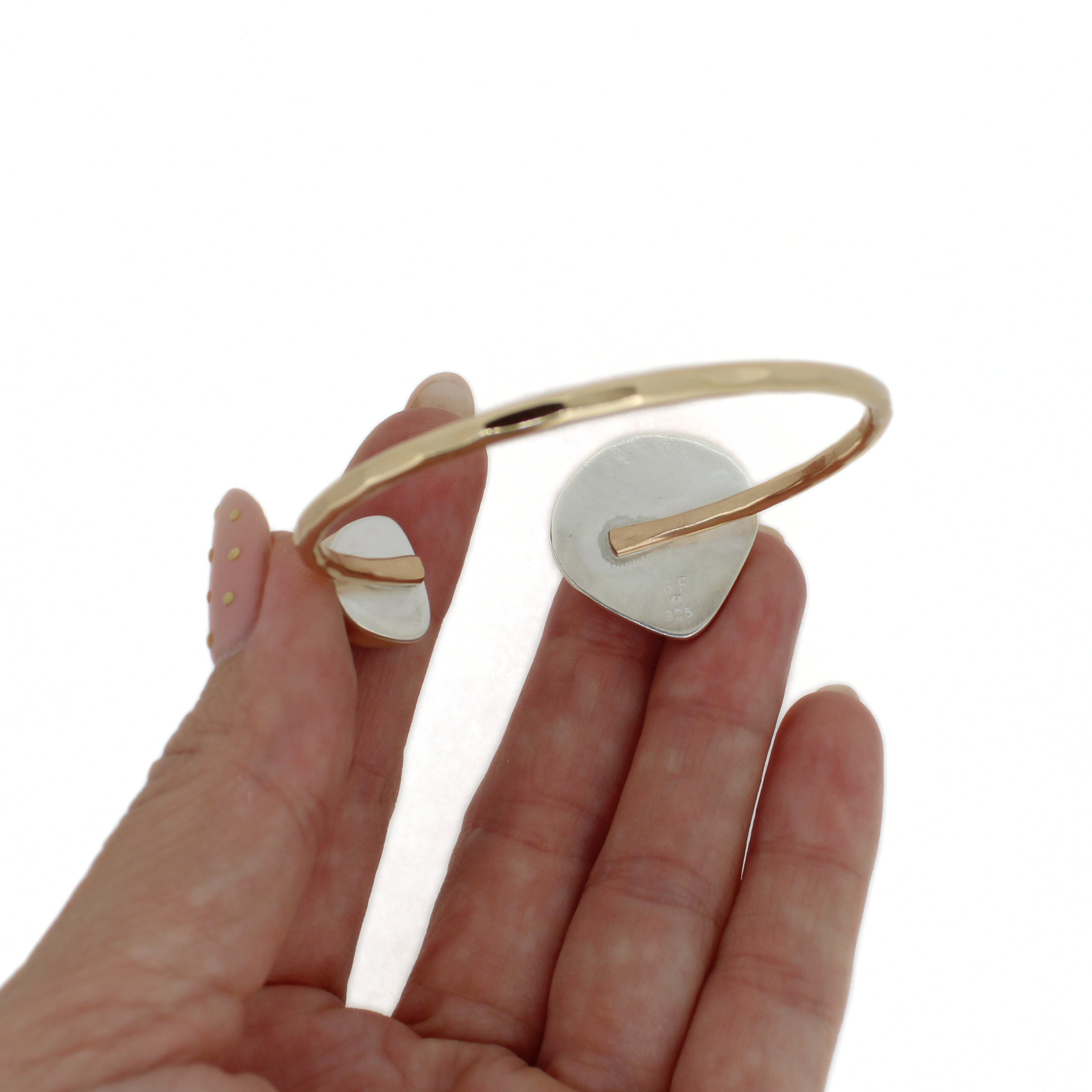Gold cuff bracelet underside view with teal sea-glass square and orange sunrise shell