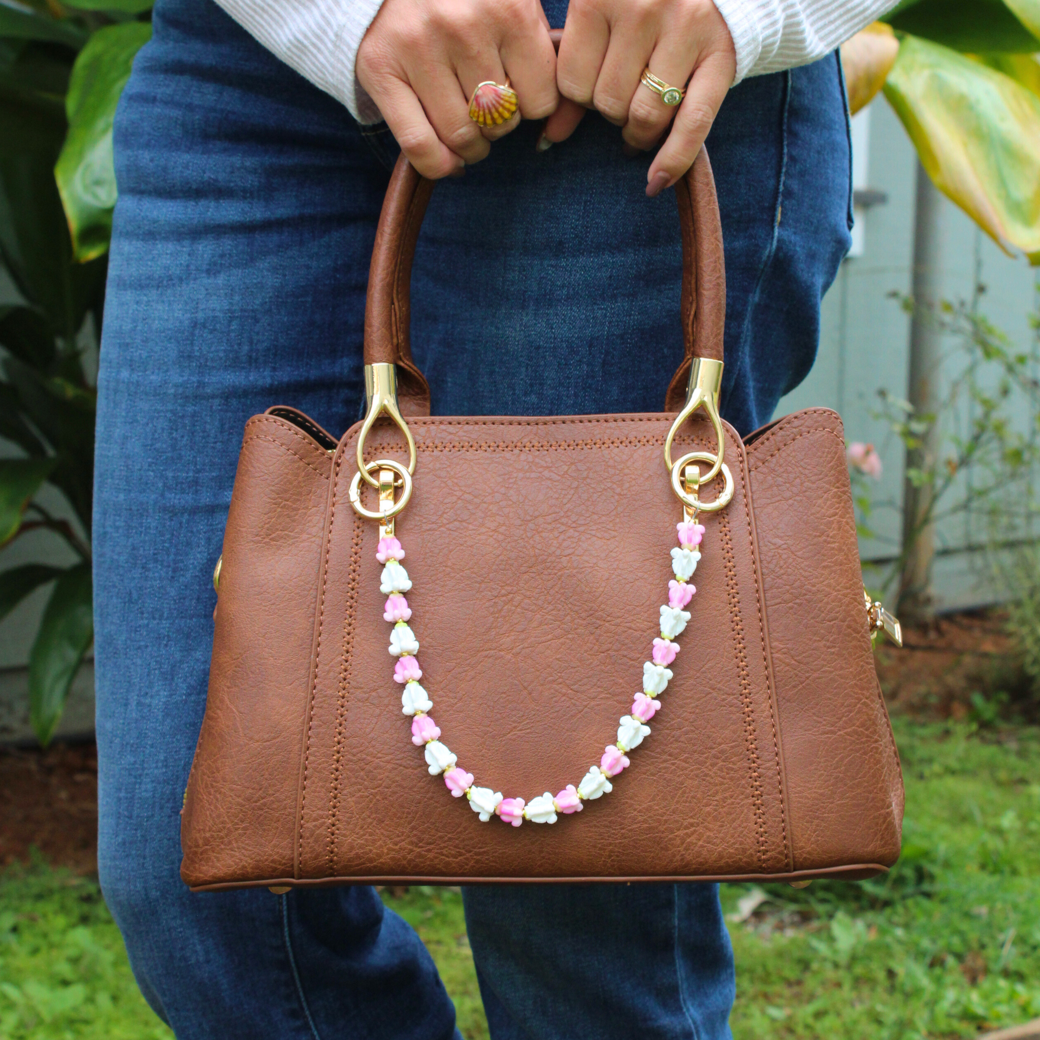Brianne & Co. purse lei accessory featuring pink and white clay crown flowers perfect for smaller handbags
