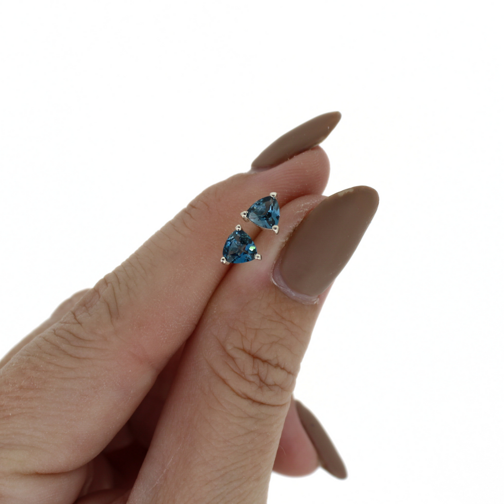 Brianne & Co. dark blue London blue topaz stud earrings in sterling silver close up front view