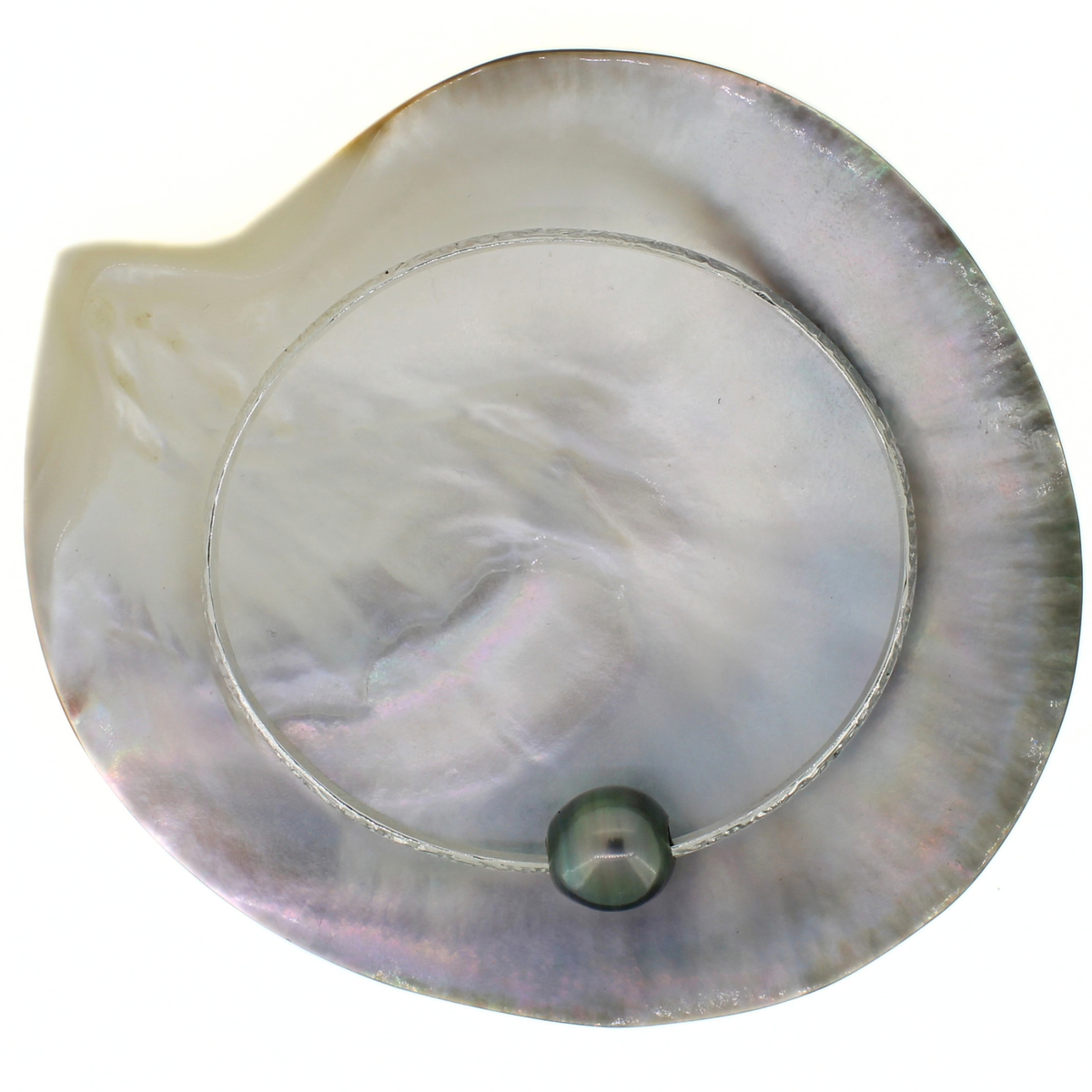 Sterling silver bangle bracelet with Tahitian pearl displayed on a shell