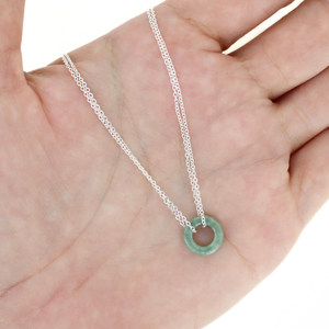 Brianne and Co. jade donut silver necklace on a hand