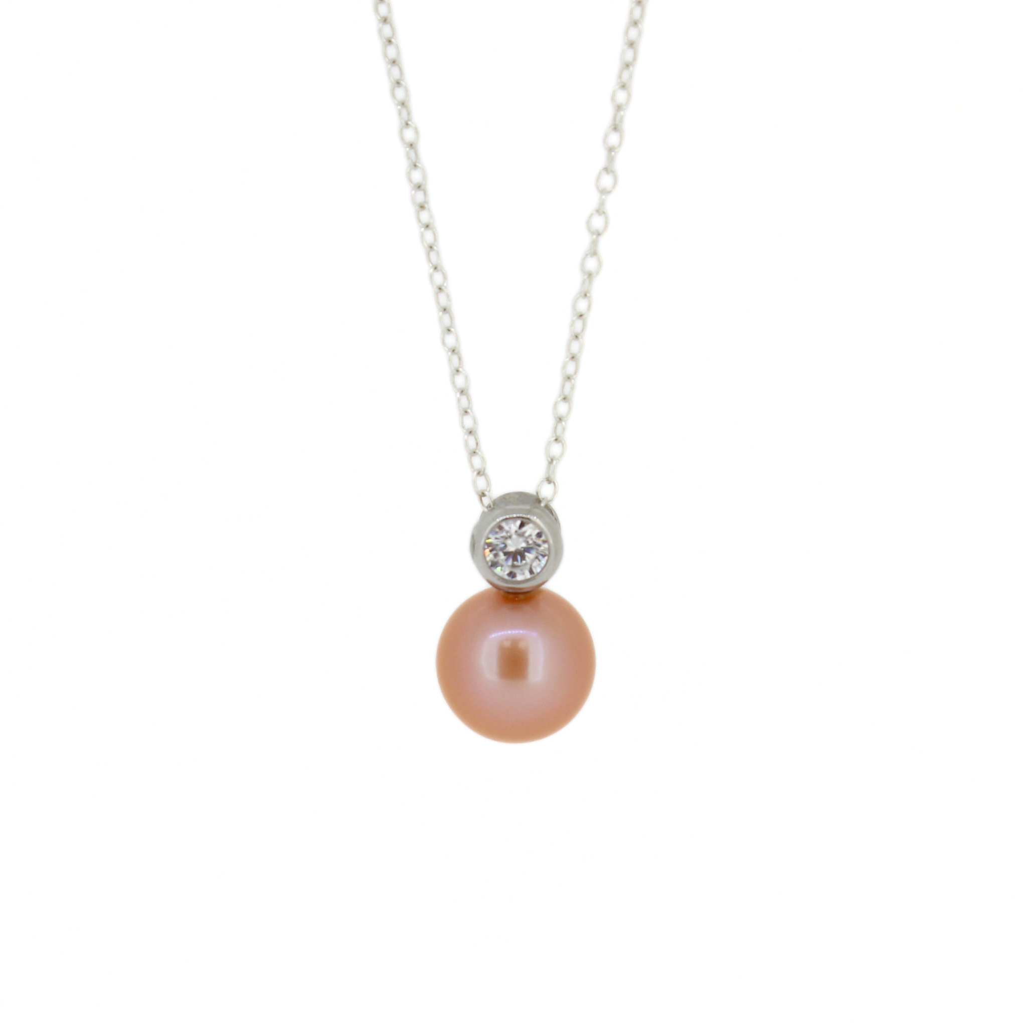Sterling silver pink pearl pendant with a clear cubic zirconia accent, hanging from a dainty silver cable chain against a white background.