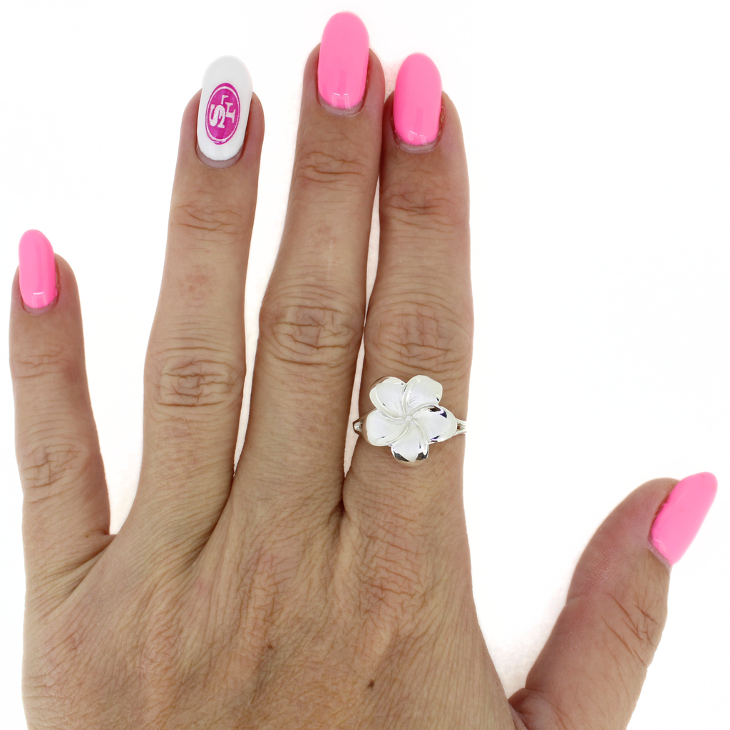 Brianne and Company sterling silver plumeria ring on a hand 