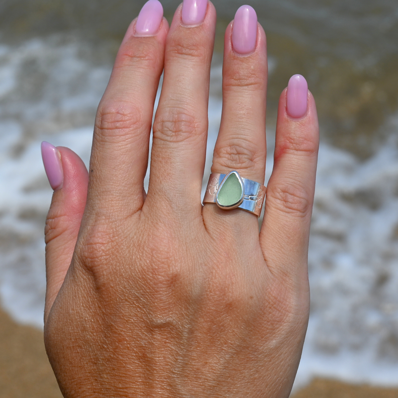 Sterling silver bezel set sea glass ring with wide puakenikeni flower stamped band size 6 handmade by Brianne & Co.