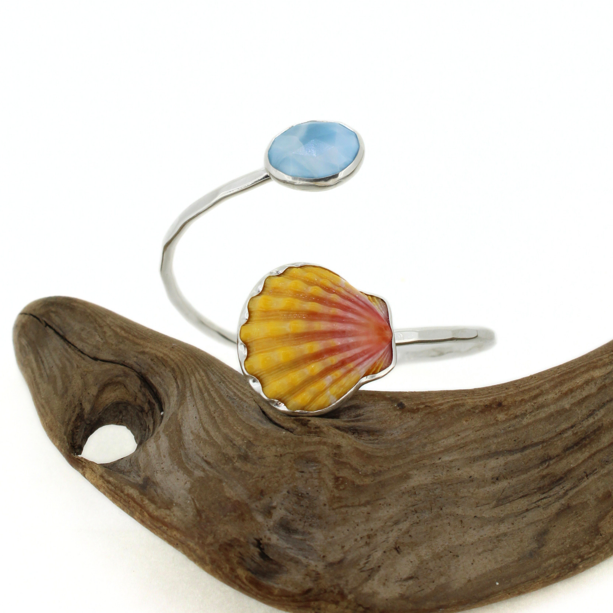 Sterling silver bypass cuff set with blue oval larimar and scalloped yellow orange shell