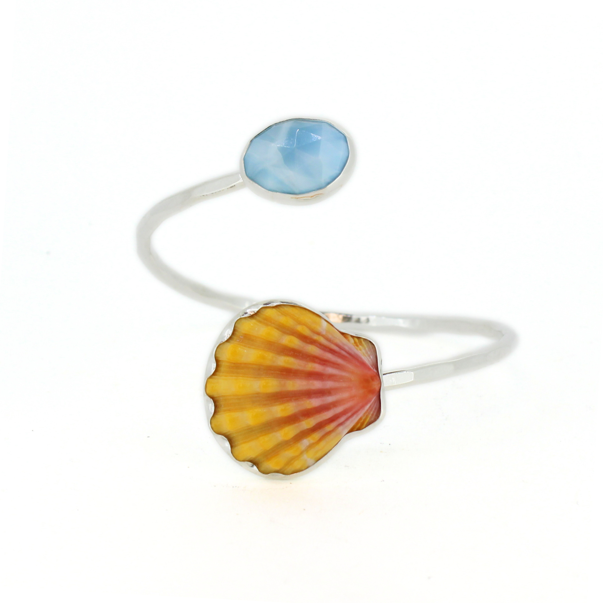 Sterling silver bypass cuff with blue oval larimar stone on a curved band