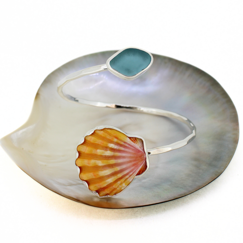 Sterling silver sunrise shell and blue sea glass bypass style cuff handmade by Brianne & Co.