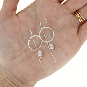 Brianne & Co. sterling silver threader hoop earrings with pink Edison keshi pearls on hand for size reference