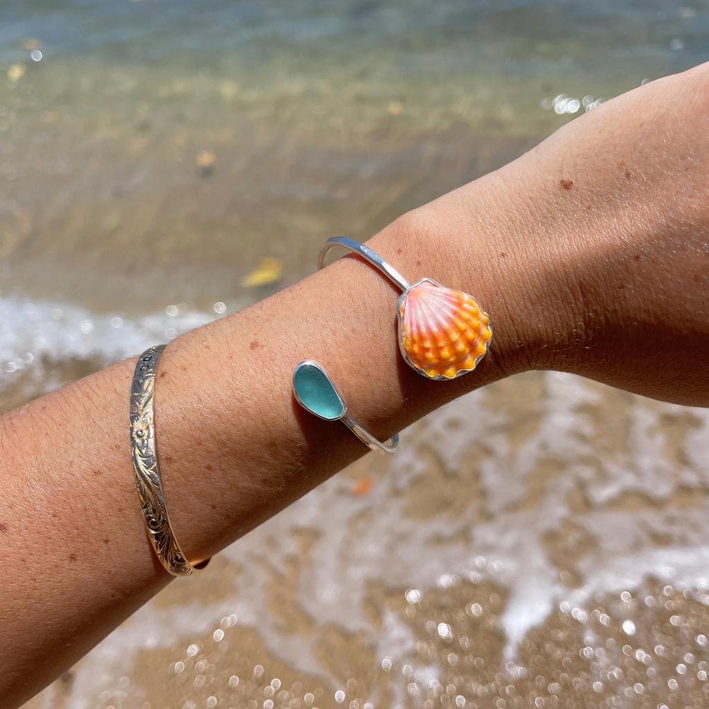 Sterling silver sunrise shell and blue sea glass bypass style cuff bracelet handmade by Brianne & Co.