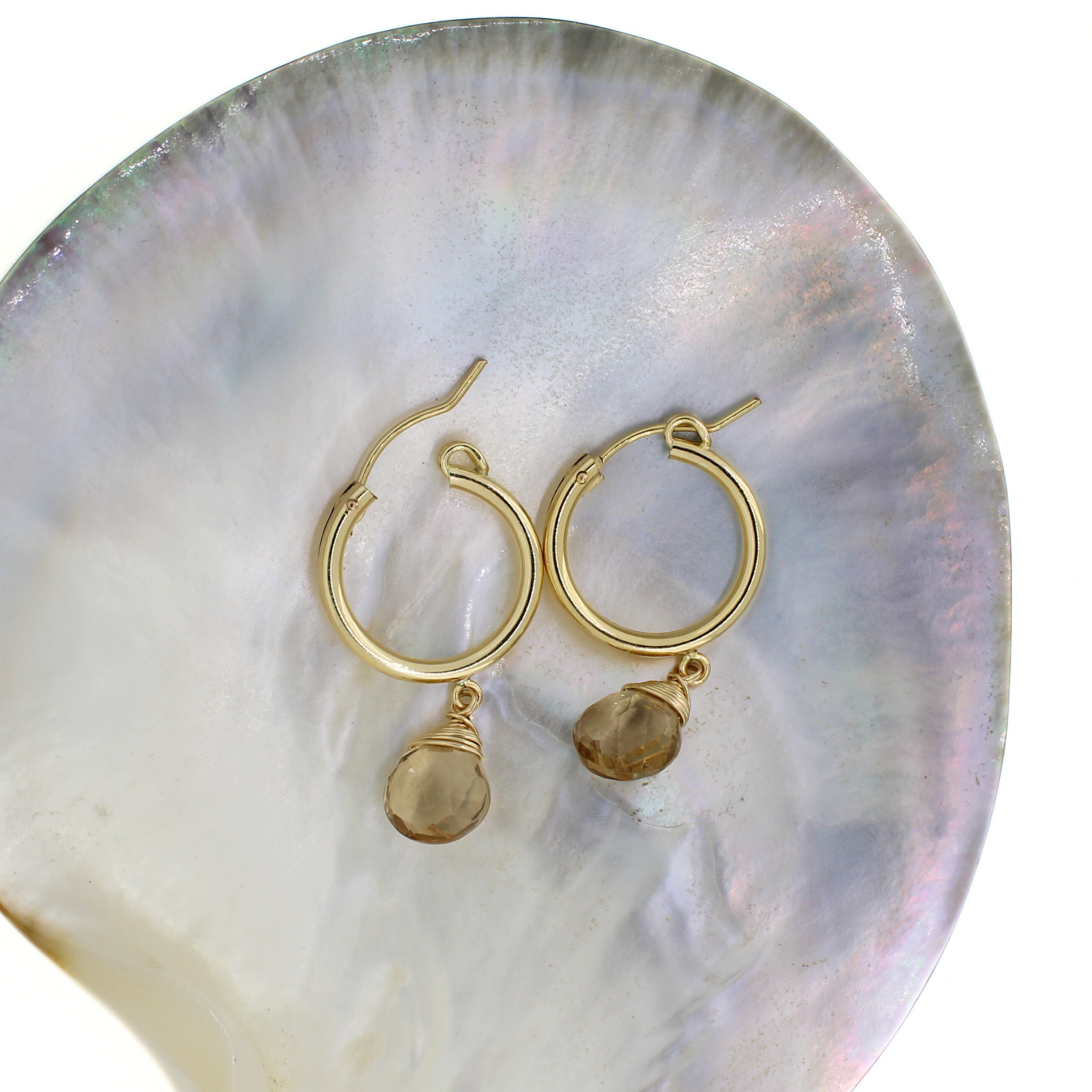 Gold hoop earrings with champagne topaz dangle charms, front view