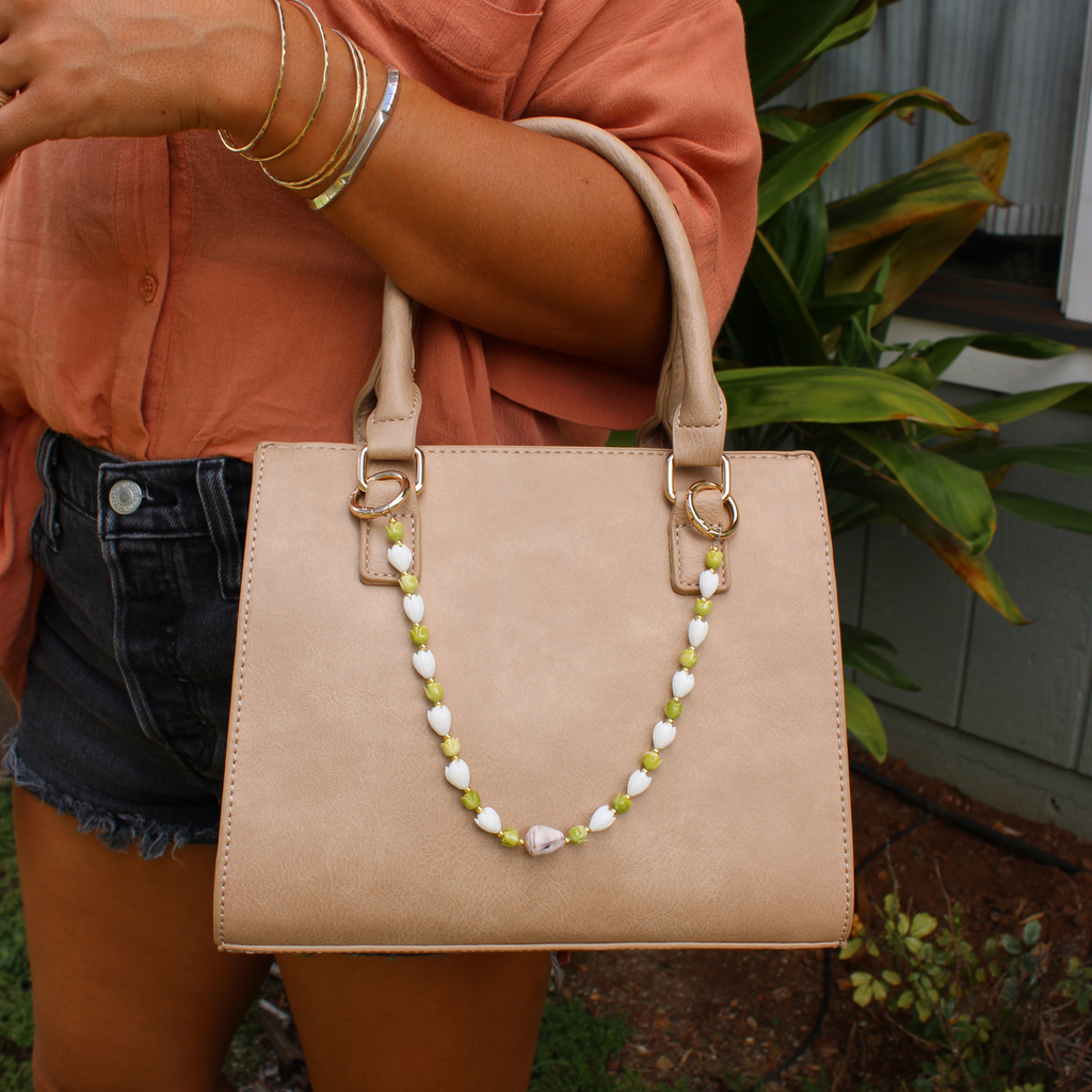 Beige handbag with decorative Hawaiian flower and cone shell purse lei handmade by Brianne & Co.