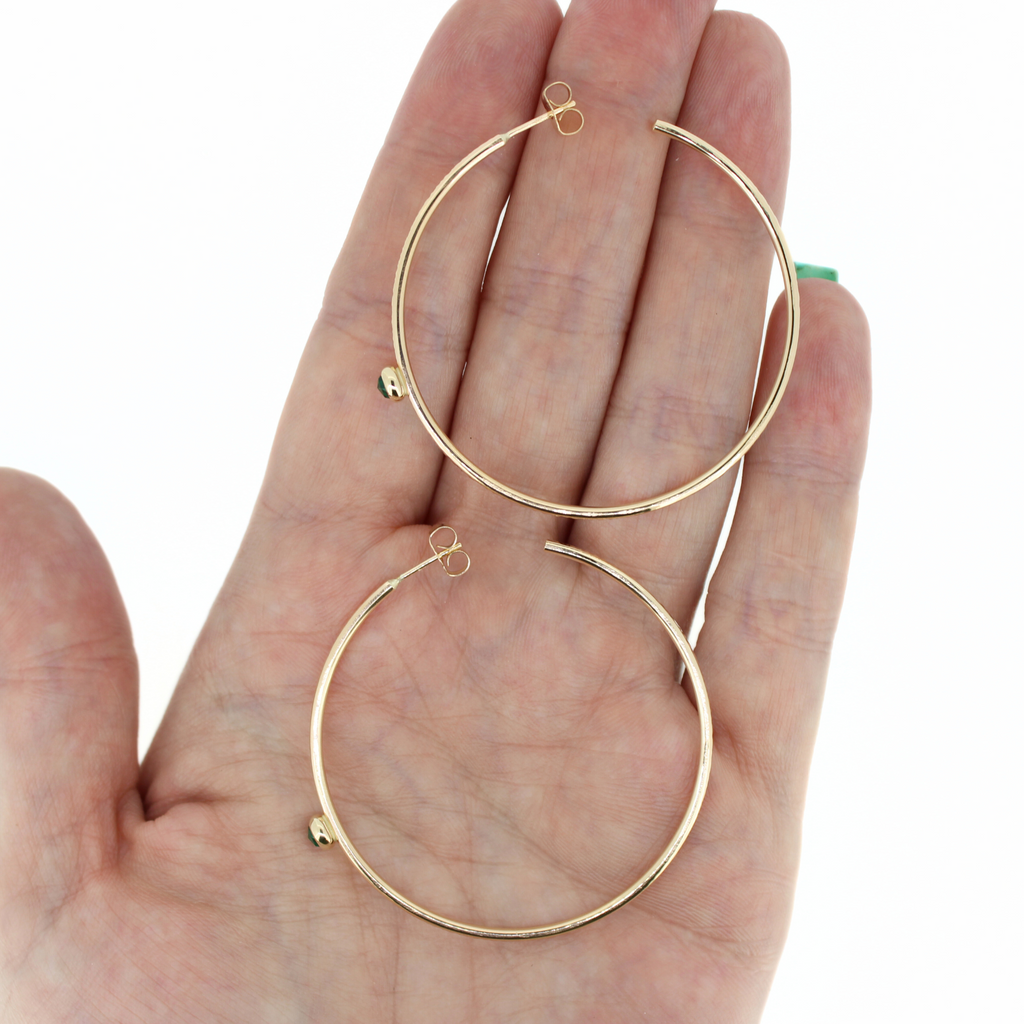 Brianne and Company gold hoops shown in hand