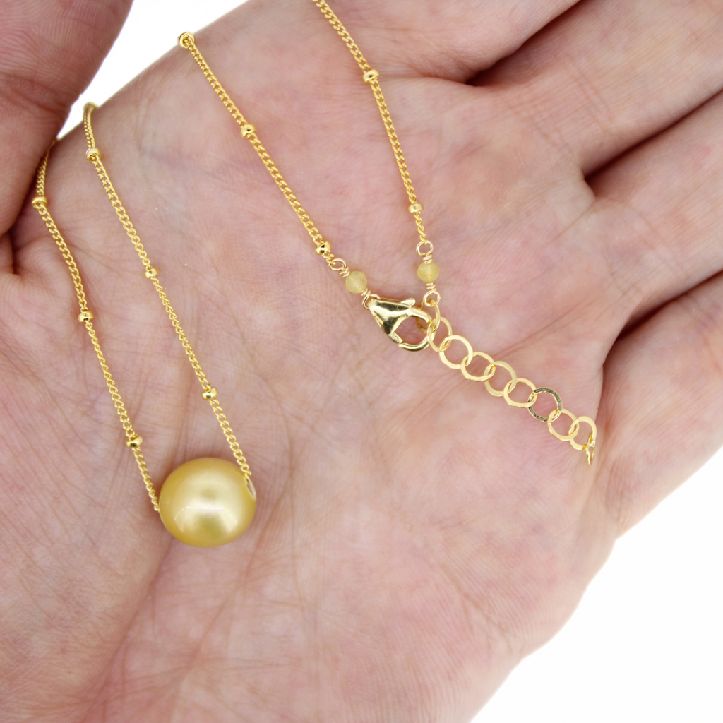 Brianne & Co gold fill golden south sea pearl necklace with 1" extender, shown in hand
