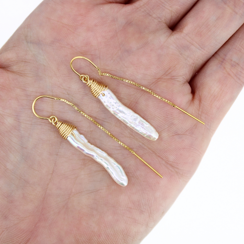 Brianne & Co white pearls hand wrapped, gold fill threader earrings shown in hand