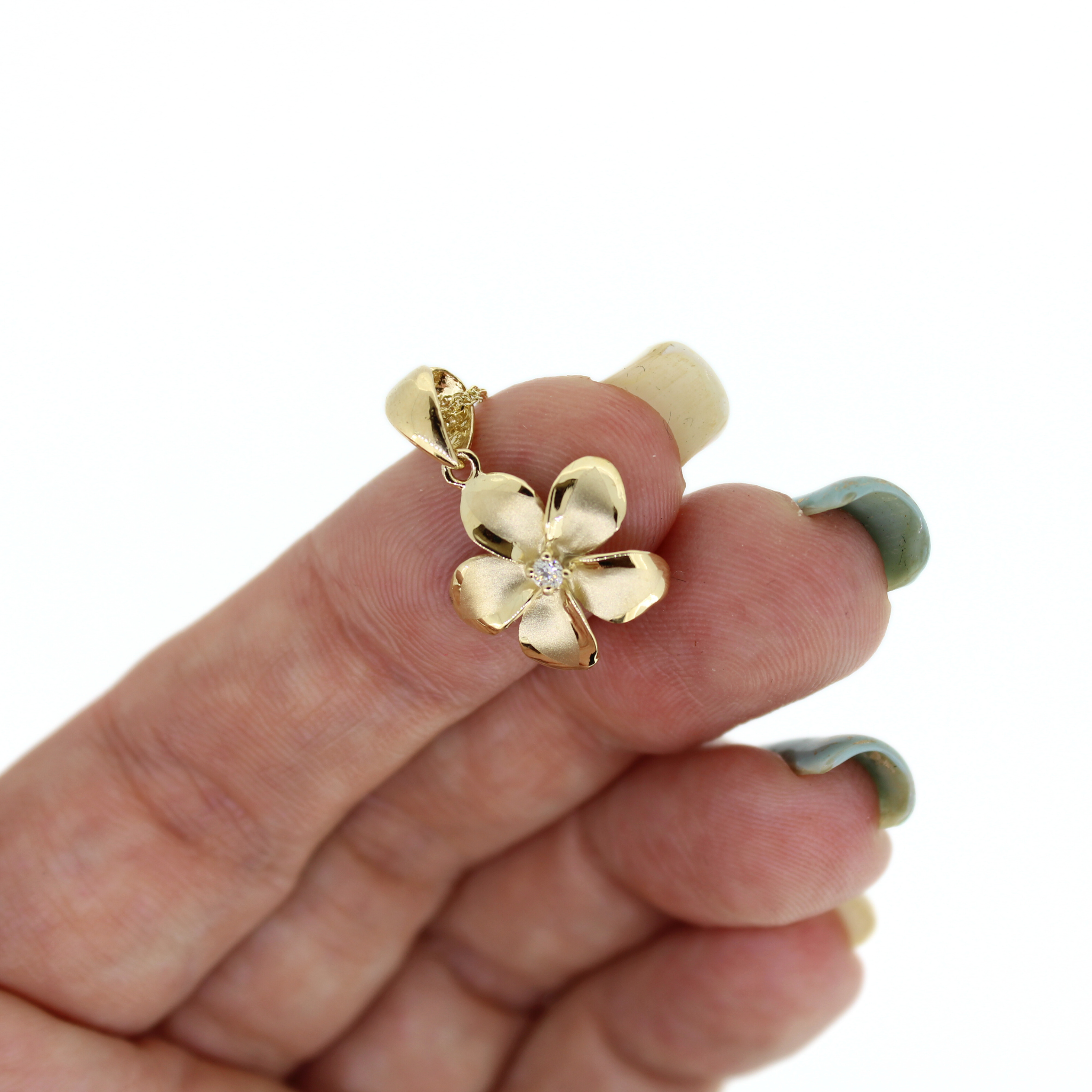Brianne & Company close up of large plumeria pendant 14k gold with diamond