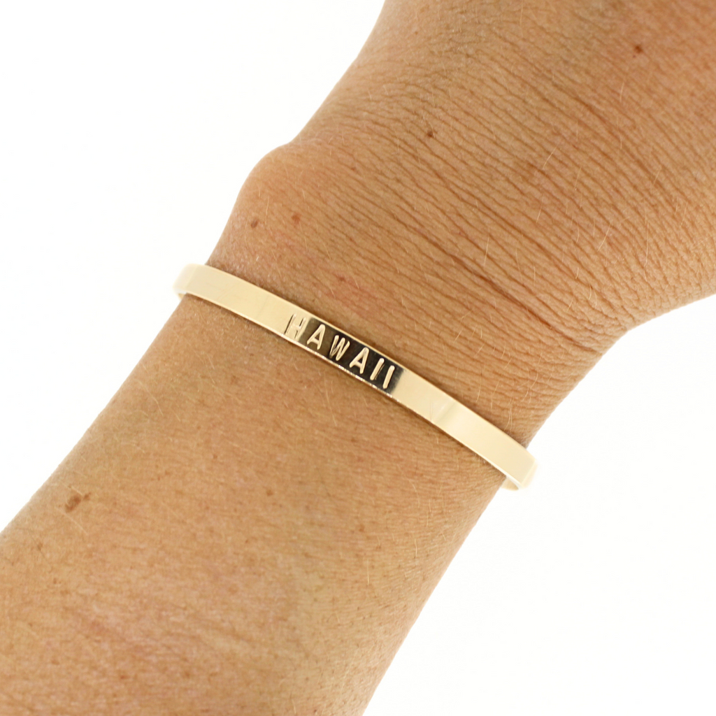 Brianne and Co Gold Fill HAWAII Stamped Cuff on a wrist