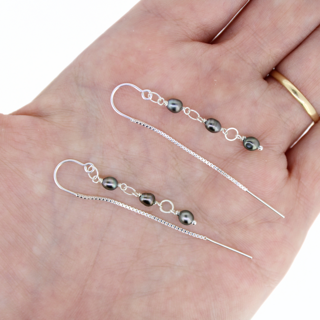 Brianne & Company natural Tahitian keshi pearls with sterling silver hardware, threader earrings shown in hand