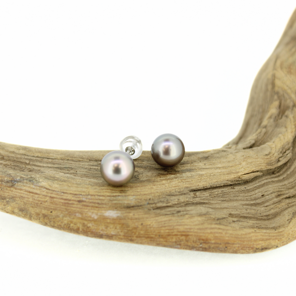 Brianne and Company silvery tahitian pearls on sterling silver posts, stud earrings shown on driftwood