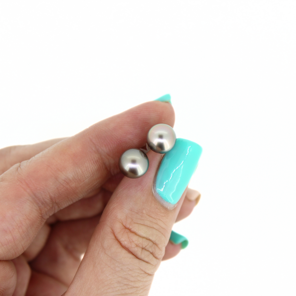 Brianne and Co Tahitian Pearl studs shown close up in hand