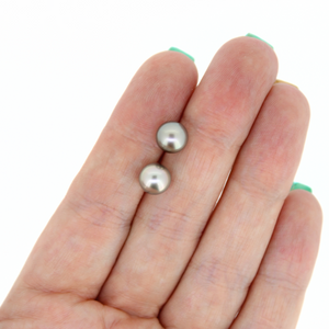 Brianne and Co sterling silver tahitian pearl studs measuring 7.9mm, shown in hand