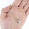 Brianne and Co floating Tahitian pearl with gold fill chain and clasp, shown in hand