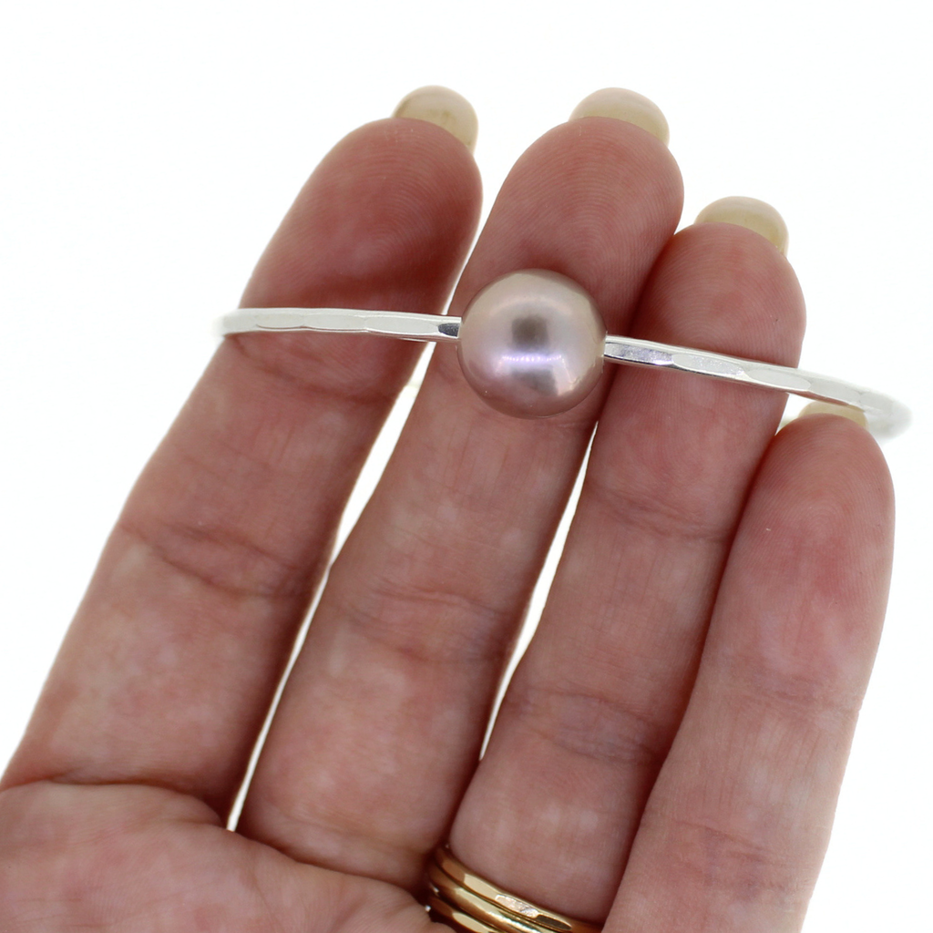 Brianne & Co. sterling silver pink Edison fresh water pearl bangle on hand for size reference