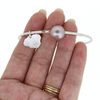Brianne & Co. sterling silver pink fresh water Edison pearl bangle with Kauai charm on hand for size reference