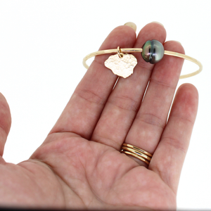 Gold Tahitian pearl bangle w/ Kauai island charm handmade by Brianne & Co. on hand for size reference