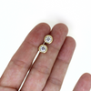 14k gold moissanite earrings shown in hand