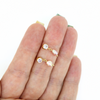 Brianne & Co cz and pearl stud earrings shown in hand
