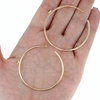 Brianne and Co gold hoop earrings shown in hand