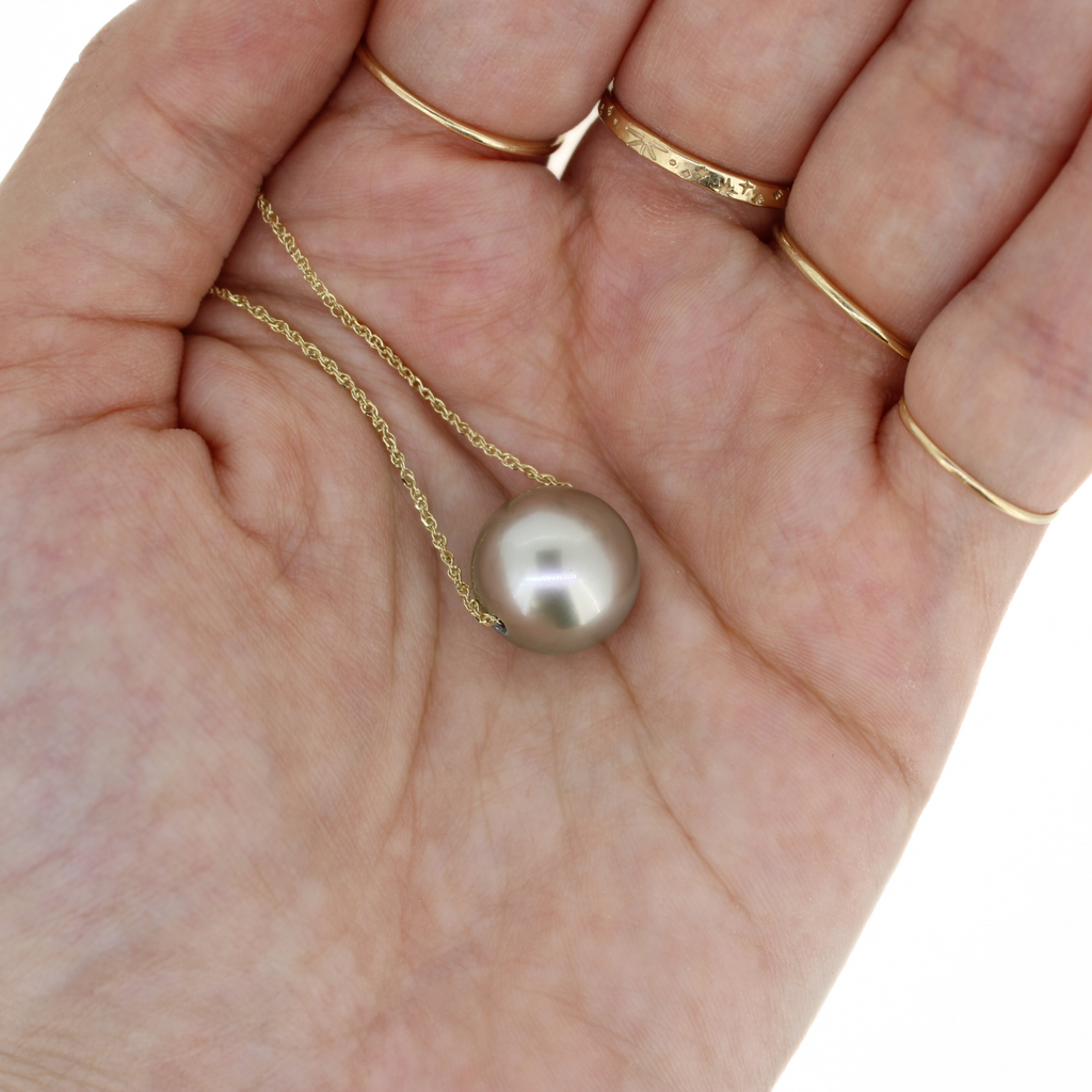 Brianne & Co. 14k Gold floating Tahitian pearl necklace in hand