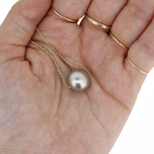 Brianne & Co. 14k Gold floating Tahitian pearl necklace in hand