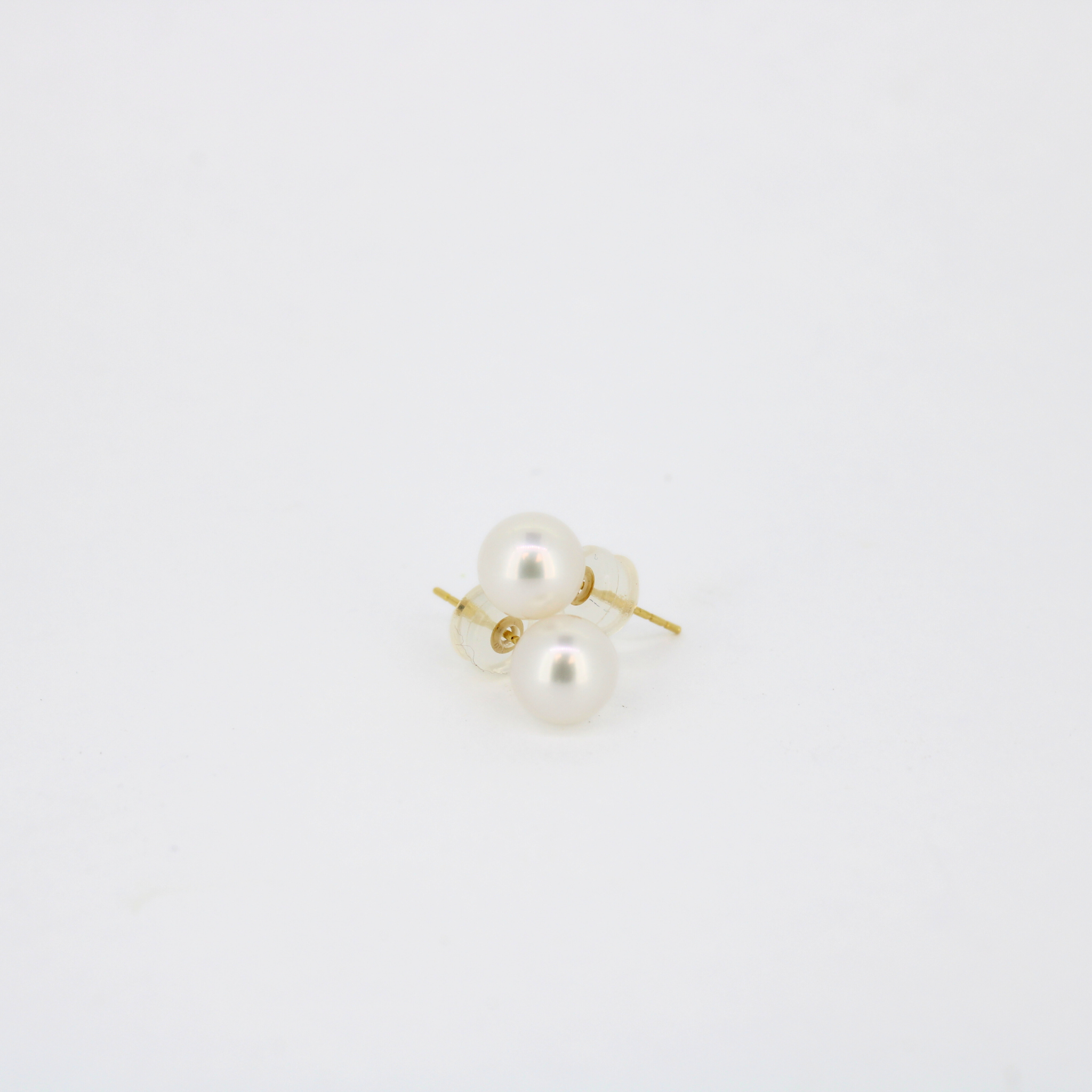 Pair of white pearl stud earrings on gold posts