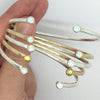 hammered cuff bracelets with opal or peridot stones on each end