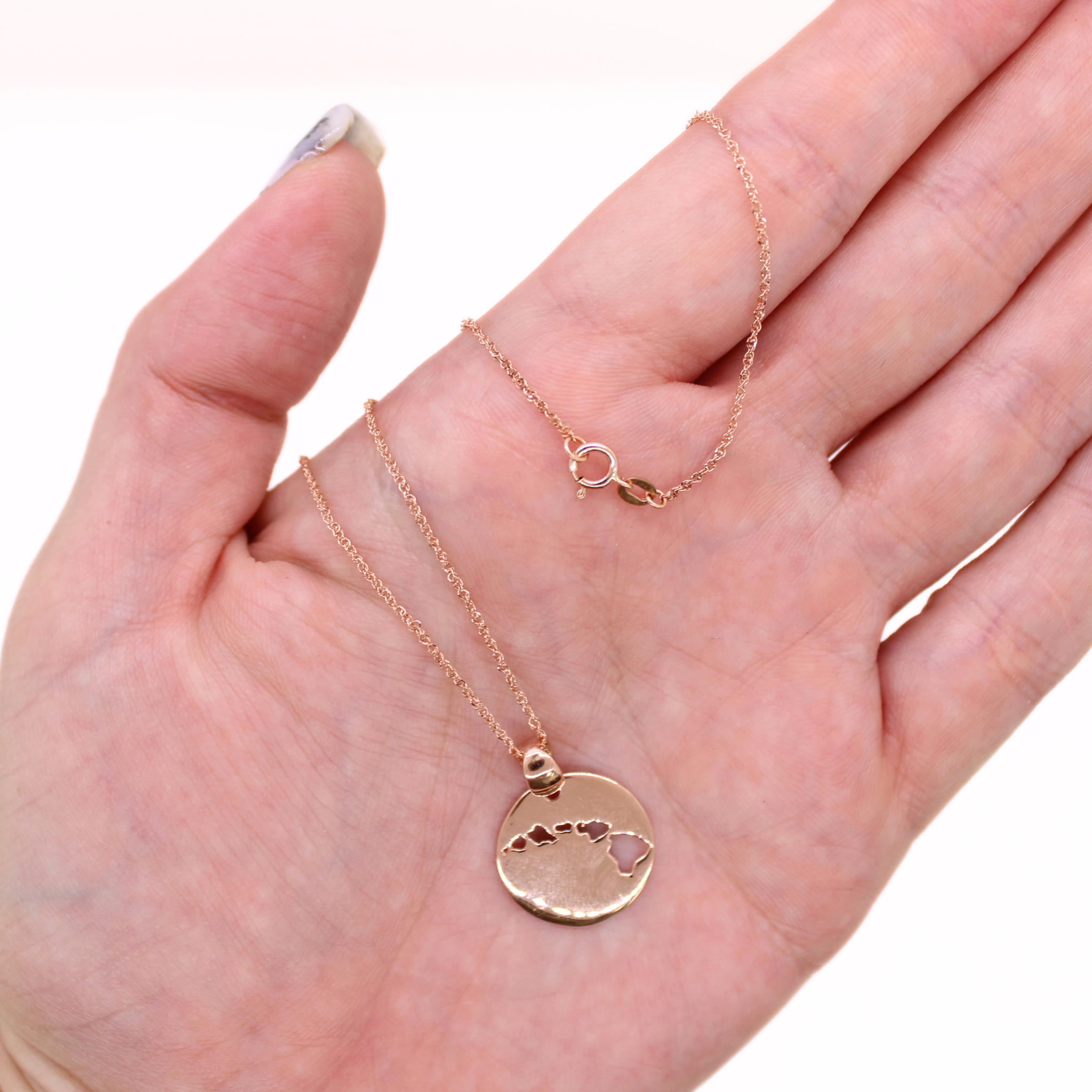 14k Rose gold Island cut out necklace, shown in hand with clasp and pendant detail