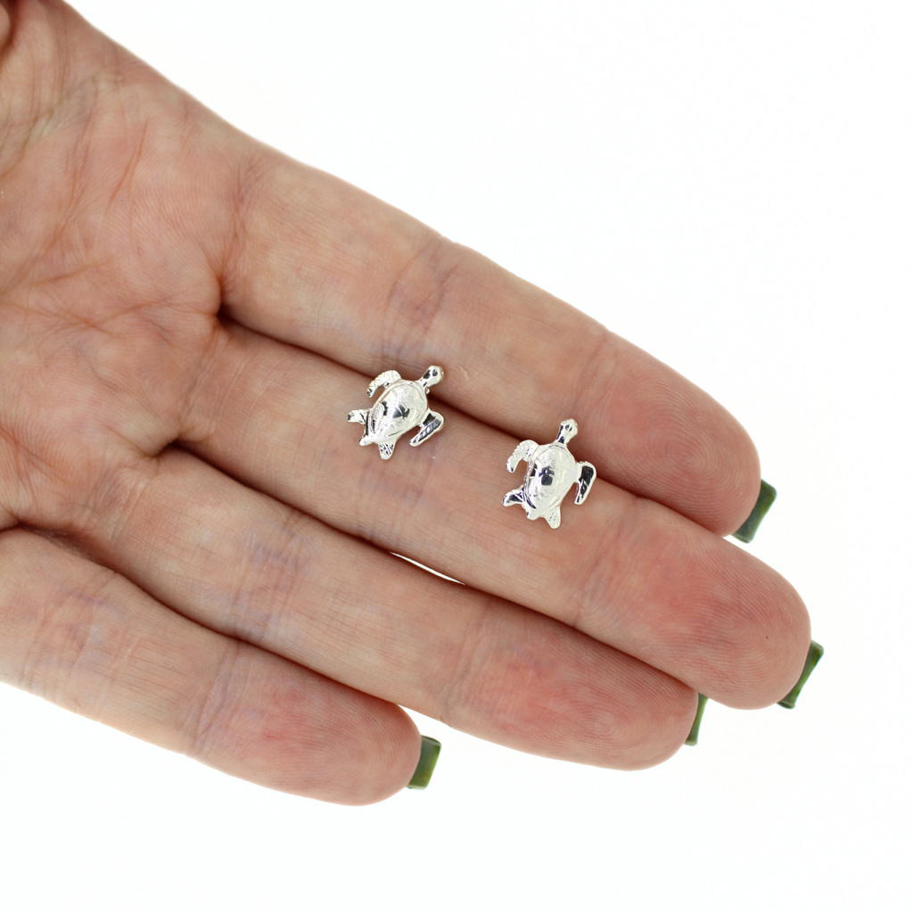 Brianne and Company sterling silver honu studs shown in hand