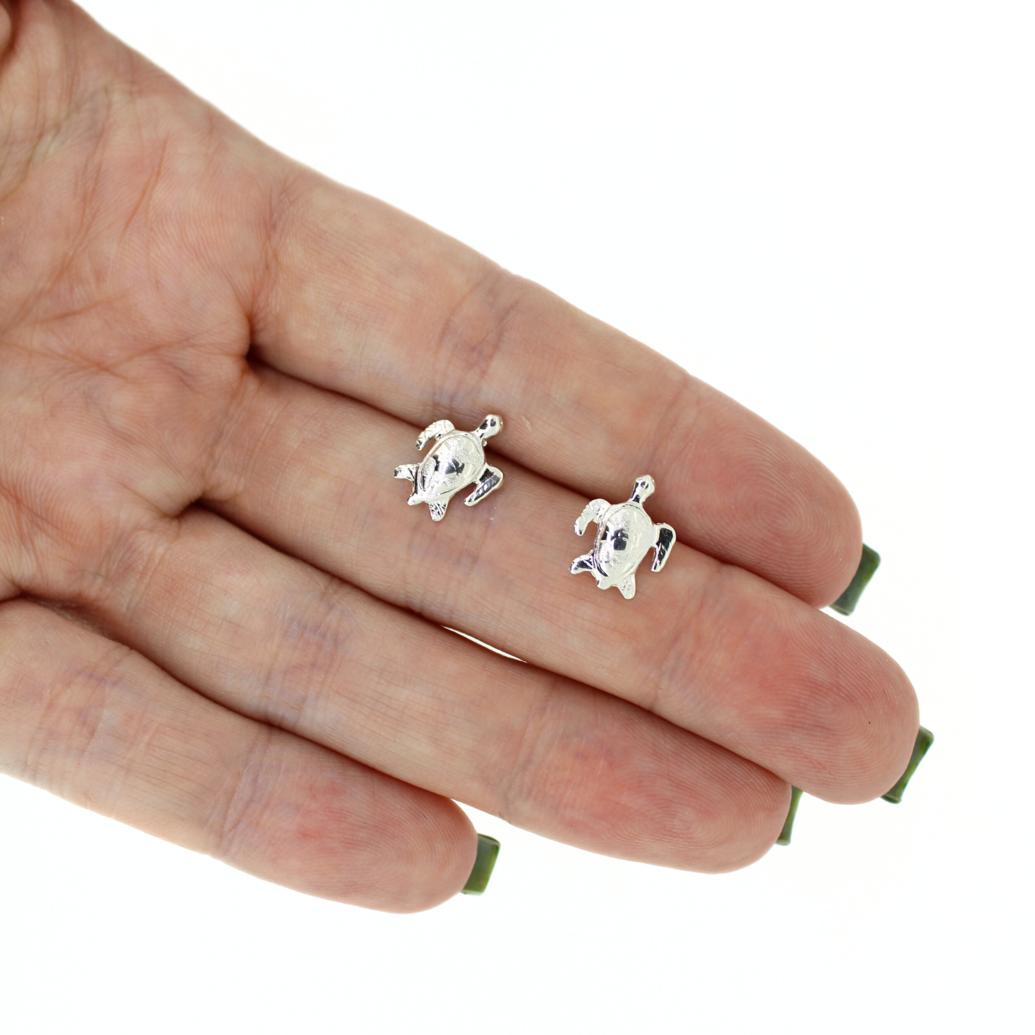 Brianne and Company sterling silver honu studs shown in hand