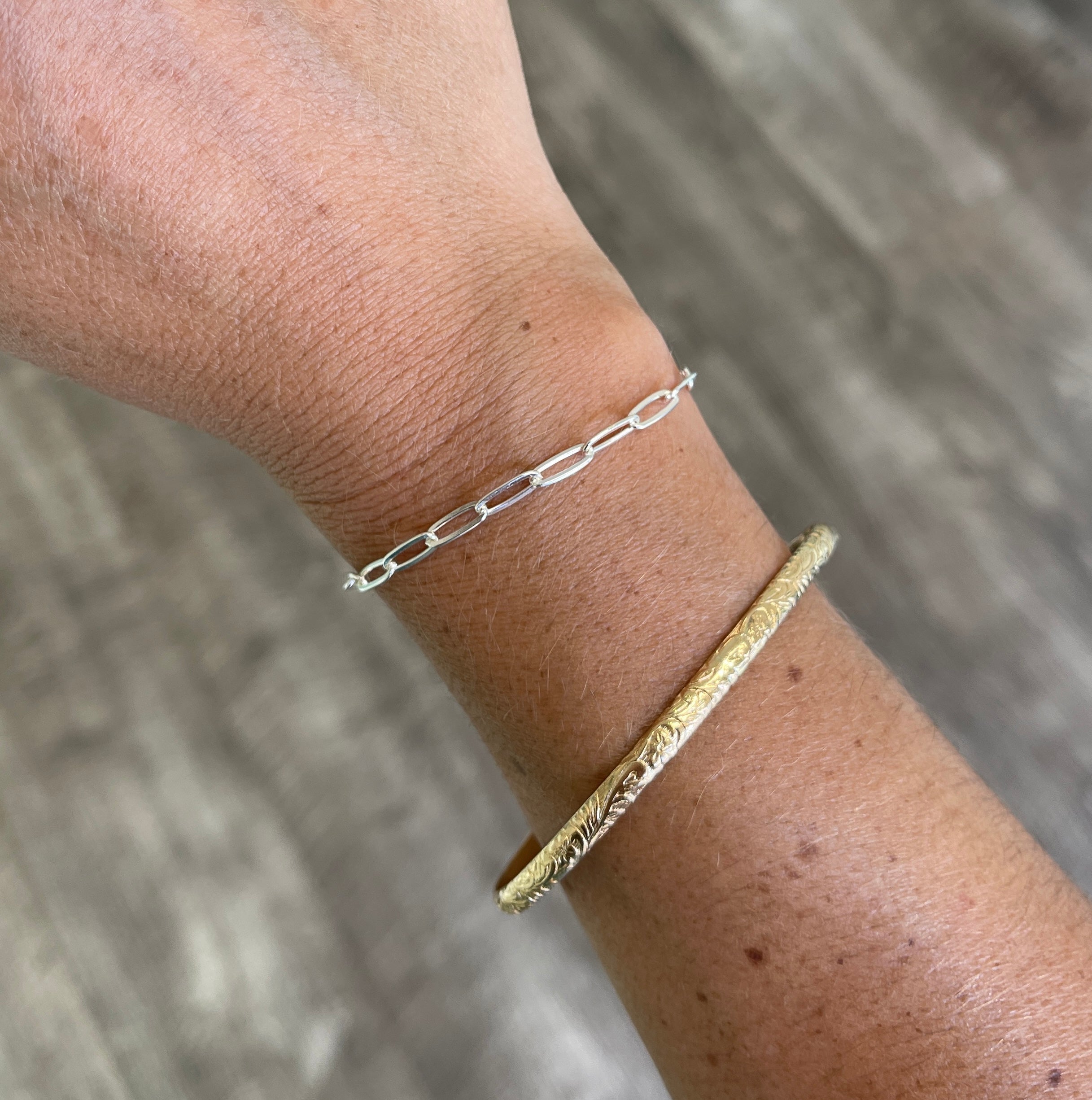 sterling silver paper clip chain bracelet shown on wrist